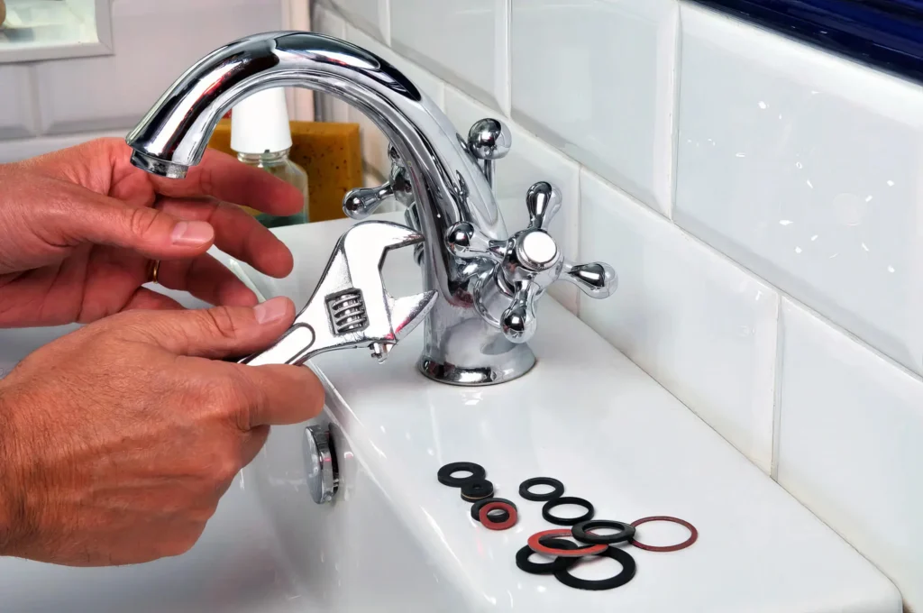 Plumber performing maintenance on a bathroom faucet in Waco