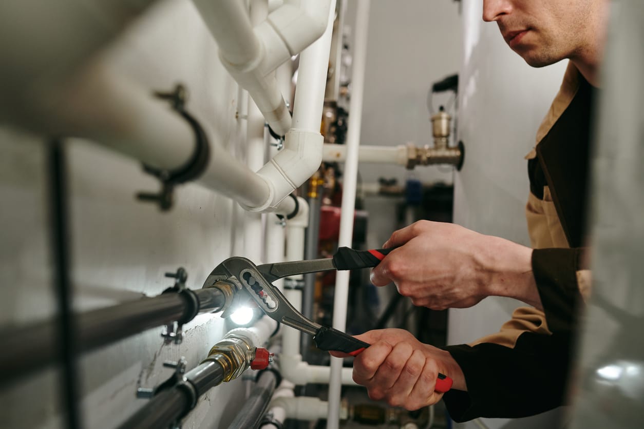 Plumbers maintaining commercial plumbing pipes in Waco