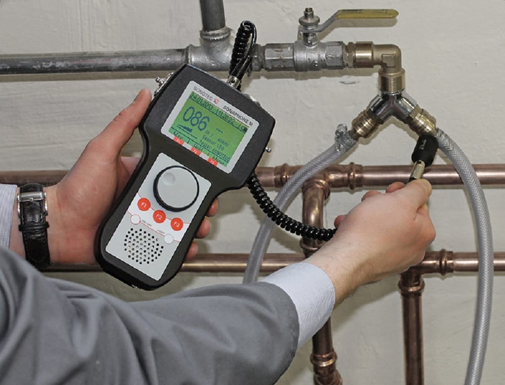Plumber testing pipes with electronic leak detection equipment in Waco