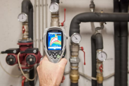 Plumber using a thermal imaging camera to inspect pipes in Waco