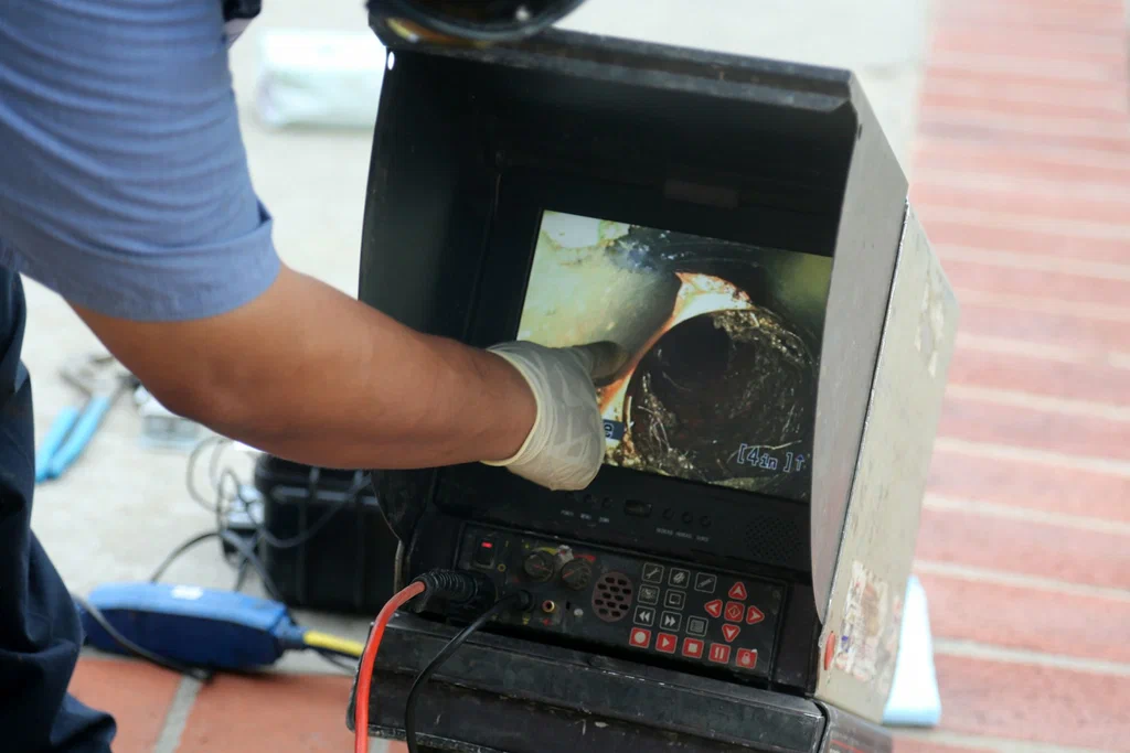 Technician viewing a drain inspection camera in Waco