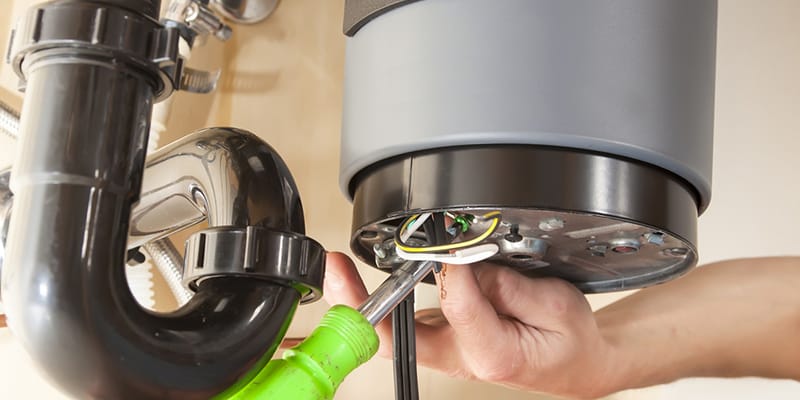 Technician repairing the heating element of a water heater in Waco