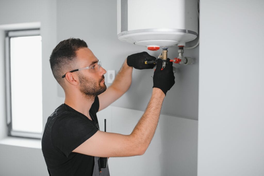 Technician performing water heater maintenance in Waco
